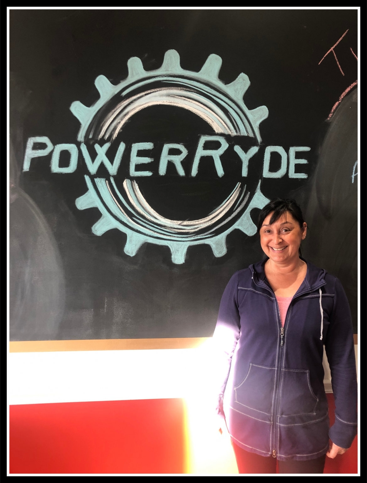 Steph Meinberg in front of PowerRyde chalk logo